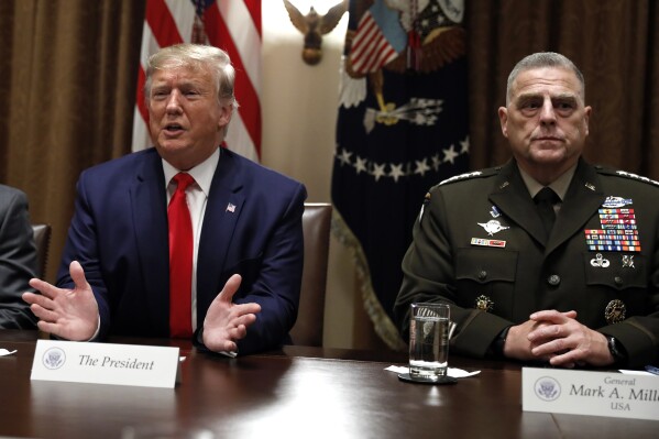 FILE - President Donald Trump speaks as the Chairman of the Joint Chiefs of Staff Gen. Mark Milley, right, listens during a briefing with senior military leaders in the Cabinet Room at the White House in Washington, Monday, Oct. 7, 2019. (AP Photo/Carolyn Kaster, File)