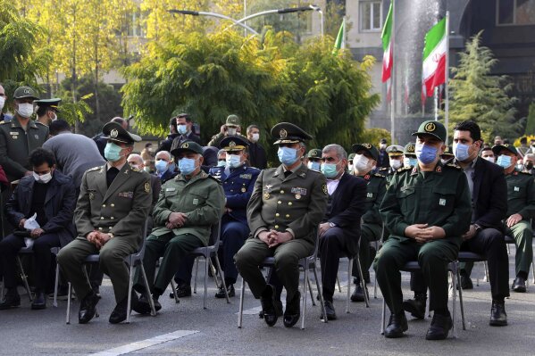 In this photo released by the official website of the Iranian Defense Ministry, military military commanders attend a funeral ceremony of Mohsen Fakhrizadeh, a scientist who was killed on Friday, in a funeral ceremony in Tehran, Iran, Monday, Nov. 30, 2020. Iran held the funeral Monday for the slain scientist who founded its military nuclear program two decades ago, with the Islamic Republic's defense minister vowing to continue the man's work "with more speed and more power." (Iranian Defense Ministry via AP)