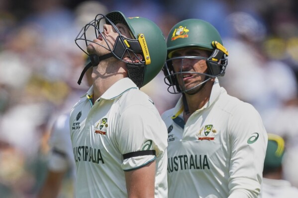 Australia's Josh Hazlewood, left, reacts after losing his wicket on day three of the World Test Championship final between South Africa and Australia at Lord's cricket ground in London, Friday, June 13, 2025. (AP Photo/Kirsty Wigglesworth)