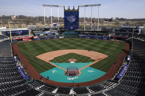 FILE - Members of the Kansas City Royals' grounds crew work off the field in preparation for the baseball season March 29, 2023, at Kauffman stadium in Kansas City, Mo. Jackson County Executive Frank White vetoed an ordinance Thursday, Jan. 18, 2024, that would have put a 3/8th-cent sales tax renewal on the April ballot to fund sports stadiums for the Kansas City Chiefs and the Royals. (AP Photo/Charlie Riedel, File)