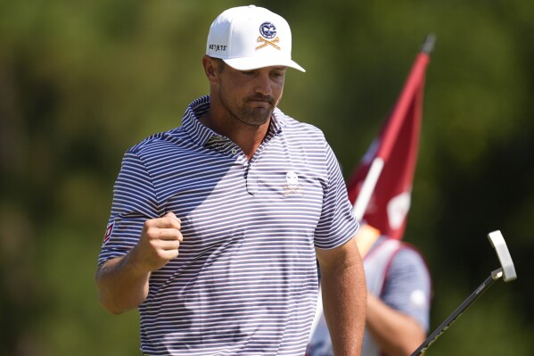 Bryson DeChambeau celebrates after a birdie on the ninth hole during the second round of the U.S. Open golf tournament Friday, June 14, 2024, in Pinehurst, N.C. (AP Photo/Mike Stewart)