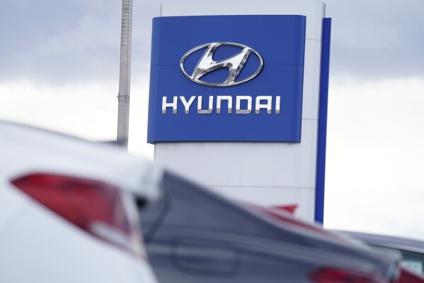 FILE - The Hyundai company logo hangs over a long row of cars at a car dealership in Centennial, Colo., Sunday, Dec. 20, 2020. Hyundai and LG Energy Solution are spending an additional $2 billion and hiring an extra 400 workers to make batteries at the automaker's sprawling U.S. electrical vehicle plant that's under construction in Georgia according to an announcement Thursday, Aug. 31, 2023. (AP Photo/David Zalubowski, File)