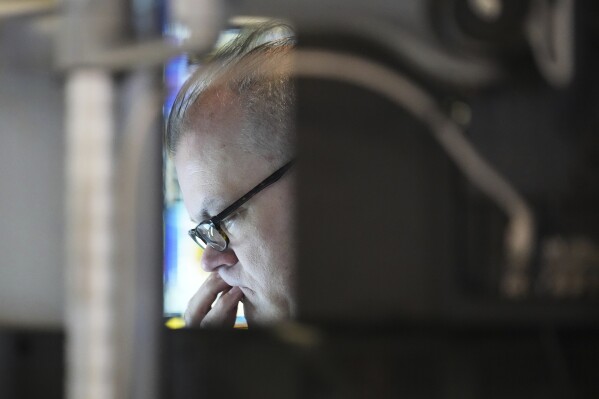 A trader works on the floor at the New York Stock Exchange in New York, Thursday, April 3, 2025. (AP Photo/Seth Wenig)