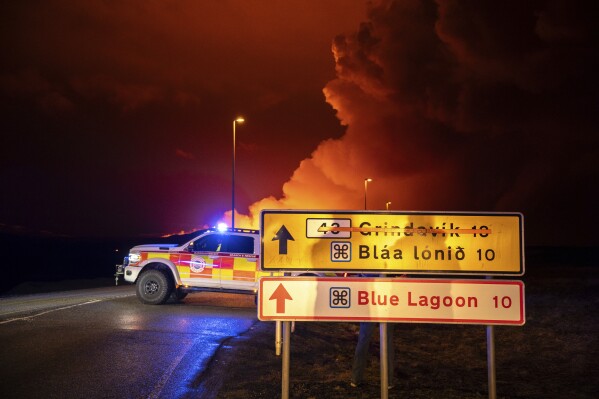 An emergency vehicle is stationed on a road leading to volcanic activity between Hagafell and Stóri-Skógfell, Iceland, on Saturday, March 16, 2024. (AP Photo/Marco di Marco)