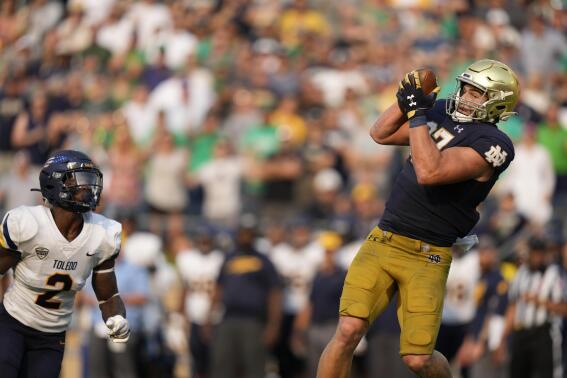Notre Dame tight end Michael Mayer (87) makes a touchdown catch in front of Toledo linebacker Dyontae Johnson (2) in the second half of an NCAA college football game in South Bend, Ind., Saturday, Sept. 11, 2021. Notre Dame won 32-29. (AP Photo/AJ Mast)