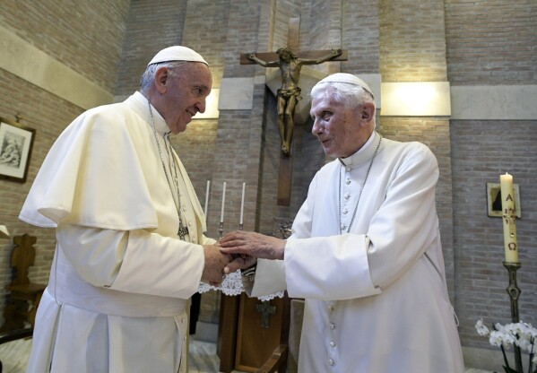 FILE - Pope Francis, left, and Pope Benedict XVI, meet each other on the occasion of the elevation of five new cardinals at the Vatican, on June 28, 2017. Pope Francis has exposed the political “maneuvers” to sway votes during the past two conclaves and denied he is planning to reform the process to elect a pope in a new book-length interview published Tuesday April 2, 2024. (L'Osservatore Romano/Pool photo via AP, File)