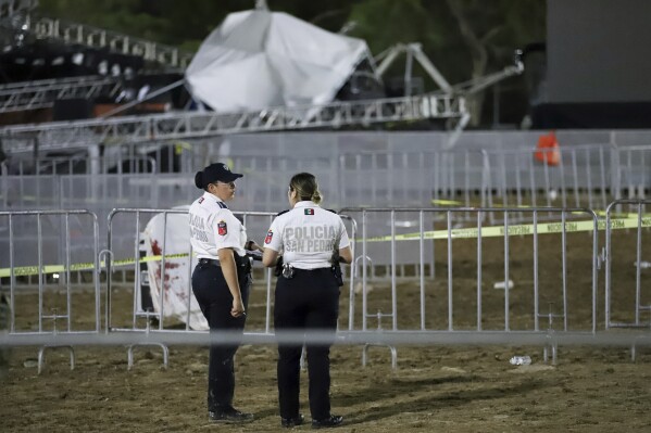 Security forces stand around a stage that collapsed due to a gust of wind during an event attended by presidential candidate Jorge Álvarez Máynez in San Pedro Garza García, on the outskirts of Monterrey, Mexico, Wednesday, May 22, 2024. President Andres Manuel Lopez Obrador confirmed that four people were killed and at least a dozen were injured. (AP Photo/Alberto Lopez)