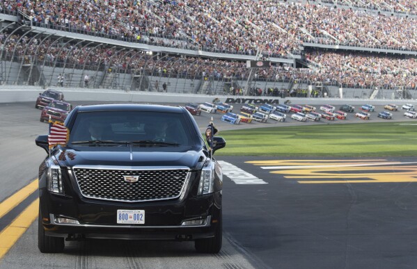 President Donald Trump and first lady Melania Trump ride in the presidential limousine as they take a pace lap ahead of the start of the NASCAR Daytona 500 auto race at Daytona International Speedway in Daytona Beach, Fla., Feb. 16, 2020. (Saul Loeb/Pool Photo via AP, File)