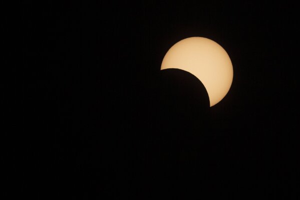 The moon passes in front of the sun during a solar eclipse in La Higuera, Chile, Tuesday, July 2, 2019. Tens of thousands of tourists and locals gaped skyward Tuesday as a rare total eclipse of the sun began to darken the heavens over northern Chile. (AP Photo/Esteban Felix)