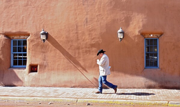 A man walks through downtown Santa Fe, N.M., Feb. 15, 2007. (AP Photo/The New Mexican, Amiran White, File)