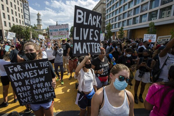 Marchers chant as they gather at Black Lives Matter Plaza near the White House in Washington, during the March on Washington, Friday, Aug. 28, 2020, commemorating the 57th anniversary of the Rev. Martin Luther King Jr.'s "I Have A Dream" speech. (AP Photo/Manuel Balce Ceneta)