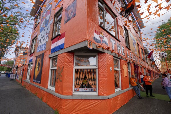 Orange tarp, orange bunting, and Dutch national flags decorate Marktweg street in The Hague, Netherlands, Thursday June 13, 2024, one day ahead of the start of the Euro 2024 Soccer Championship. (AP Photo/Peter Dejong)