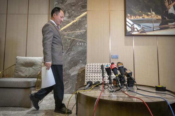 FILE - Chinese scientist He Jiankui arrives to speak at a brief press conference in Beijing on Feb. 21, 2023. He, a Chinese scientist who set off an ethical debate five years ago with claims that he made the world's first genetically edited babies, said that he hopes to research rare hereditary diseases in Hong Kong. (AP Photo/Mark Schiefelbein, File)