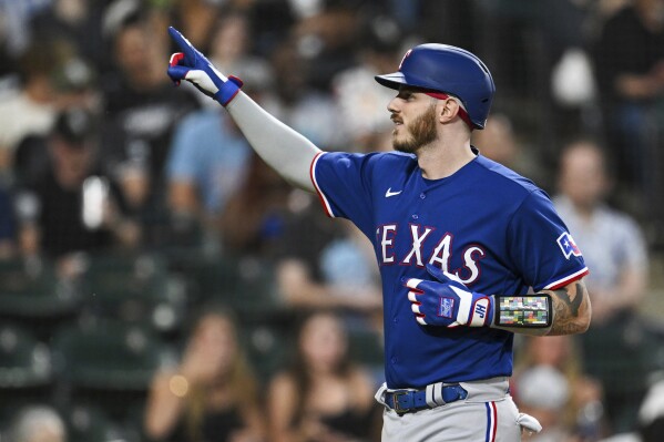 Texas Rangers' Jonah Heim reacts after his three-run home run against the Chicago White Sox during the fifth inning of a baseball game Wednesday, June 21, 2023, in Chicago. (AP Photo/Quinn Harris)