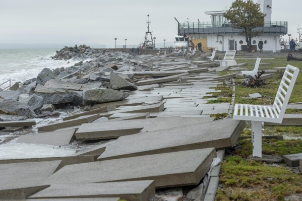 Pavement slabs affected by the storm during the night on the beach promenade in Sassnitz, Germany, Saturday Oct. 21, 2023. A storm continued to batter Britain, northern Germany and southern Scandinavia early Saturday with powerful winds, heavy rain and storm surges that caused floods, power outages, evacuations, traffic disruptions. (Georg Moritz/dpa via AP)