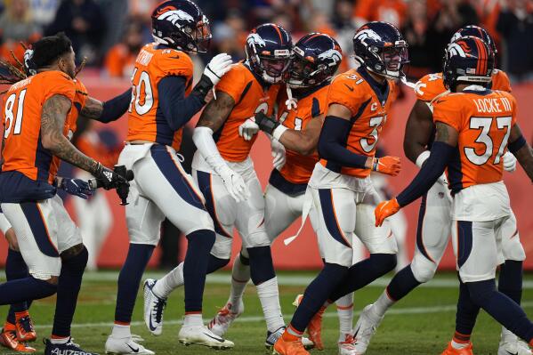 DENVER, CO - DECEMBER 18: Denver Broncos cornerback Pat Surtain II (2) goes  up to grab an interception during an NFL game between the Arizona Cardinals  and the Denver Broncos on December