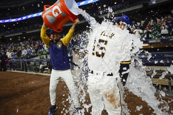 Milwaukee Brewers' Willy Adames douces Tyrone Taylor after a baseball game against the St. Louis Cardinals Wednesday, Sept. 27, 2023, in Milwaukee. The Brewers won 3-2. (AP Photo/Morry Gash)