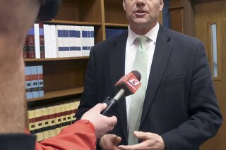 
              FILE - In this Nov. 30, 2018 file photo, then Kansas Secretary of State Kris Kobach responds to questions from reporters in Topeka, Kan. An appeals court in Salt Lake City, will consider Monday, March 18, 2019, the constitutionality of a struck down Kansas statute that had required people to provide documents proving U.S. citizenship before they could register to vote. (AP Photo/John Hanna, File)
            