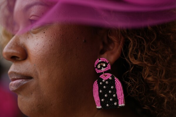 A race fan watches from the stands at Churchill Downs before the 151st running of the Kentucky Oaks horse race Friday, May 2, 2025, in Louisville, Ky. (AP Photo/Brynn Anderson)