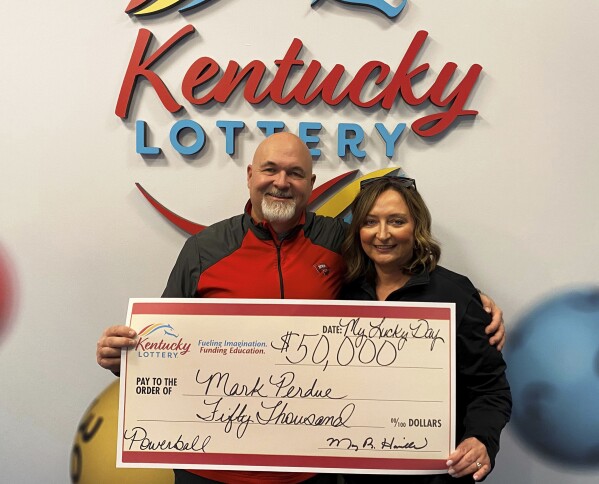 In this recent image provided by Kentucky Lottery, Mark Perdue and his wife pose at the Kentucky Lottery's headquarters in Louisville, Ky. Luck struck twice for the Kentucky couple who thought they lost a winning Powerball ticket. The Bowling Green couple found out about a week after purchasing the ticket in late October that they had won $50,000, but they couldn't find the ticket, the Kentucky Lottery said in a statement. Three months later, Perdue went to check out the condition of a car at work and saw the ticket inside. The couple claimed $36,000 after taxes the following day. (Kentucky Lottery via AP)