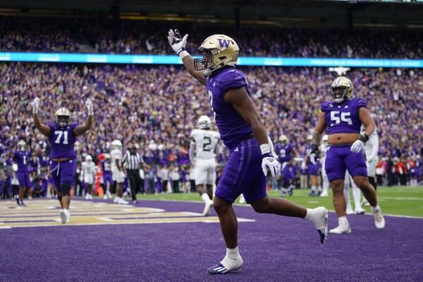 Washington running back Dillon Johnson reacts after scoring a touchdown against Oregon during the first half of an NCAA college football game, Saturday, Oct. 14, 2023, in Seattle. (AP Photo/Lindsey Wasson)
