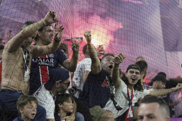 PSG fans celebrate after PSG's Achraf Hakimi scores his side's opening goal during the Champions League final soccer match between Paris Saint-Germain and Inter Milan at the Allianz Arena in Munich, Germany, Saturday, May 31, 2025. (AP Photo/Martin Meissner)