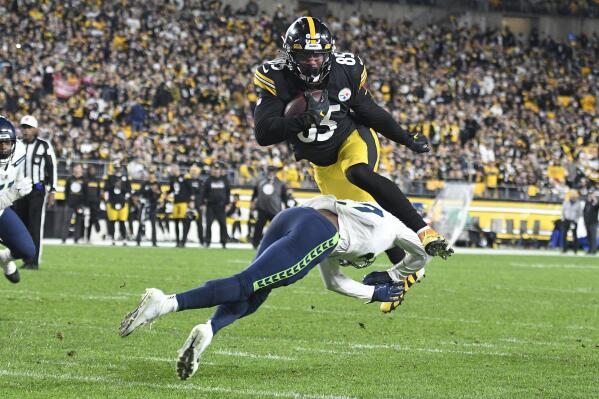 Pittsburgh Steelers tight end Eric Ebron (85) leaps over Seattle Seahawks defensive back Marquise Blair (27) on his way to a touchdown after caching pass during the first half an NFL football game, Sunday, Oct. 17, 2021, in Pittsburgh. (AP Photo/Don Wright)