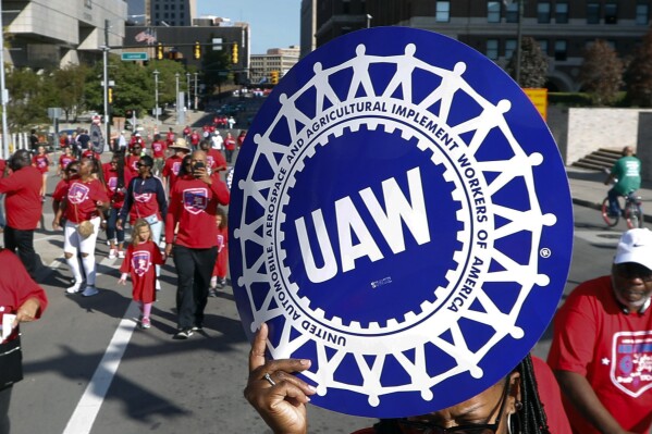 FILE - United Auto Workers members walk in the Labor Day parade in Detroit, Sept. 2, 2019. Automaker Stellantis has made a counteroffer to the United Auto Workers that includes wage increases in each year of a new four-year contract totaling 14.5%. The raises, which would be for most workers, doesn’t include any lump sum payments. (AP Photo/Paul Sancya, File)