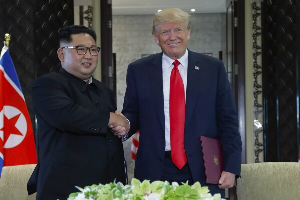 
              North Korea leader Kim Jong Un and U.S. President Donald Trump shake hands after a document signing at the Capella resort on Sentosa Island Tuesday, June 12, 2018 in Singapore. (AP Photo/Evan Vucci)
            