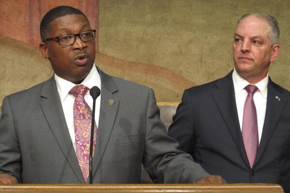 FILE - Transportation and Development Secretary Shawn Wilson, left, speaks about proposed surplus spending on roadwork as Louisiana Gov. John Bel Edwards listens, March 28, 2018, in Baton Rouge, La. Wilson, who is considered a possible Democratic gubernatorial candidate, informed Edwards on Wednesday, Feb. 15, 2023, that he is retiring from his state DOTD position. (AP Photo/Melinda Deslatte, File)