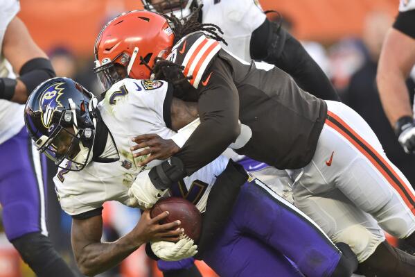 FILE - Cleveland Browns linebacker Jadeveon Clowney (90) sacks Baltimore Ravens quarterback Tyler Huntley (2) during the second half of an NFL football game, Sunday, Dec. 12, 2021, in Cleveland. After a disappointing 2021 season, the Browns head into free agency looking to plug holes — some bigger than others. On defense, the Browns would like to re-sign edge rusher Jadeveon Clowney, who had a solid first season in Cleveland. (AP Photo/David Richard, File)