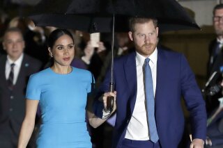 FILE - Prince Harry and Meghan, the Duke and Duchess of Sussex arrive at the annual Endeavour Fund Awards in London on March 5, 2020. The couple are suing to stop the sale of a photo of their son Archie that they say was shot at their Los Angeles-area home in invasion of their privacy. The suit filed Thursday says it was brought on by “serial intrusions of the privacy of a 14-month-old child.” It says photographers have perched on a ridge to peer into their private spaces, and photo-shooting drones have constantly flown over their home. The anonymous sellers say the photo was shot on a Malibu outing, but the suit says Archie hasn't been in public since they moved to California earlier this year.  (AP Photo/Kirsty Wigglesworth, File)
