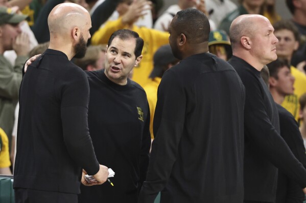 Baylor head coach Scott Drew, center, talks with his coaches after getting a second technical foul in the second half of an NCAA college basketball game against Iowa State, Saturday, Feb. 3, 2024, in Waco, Texas. (AP Photo/Rod Aydelotte)