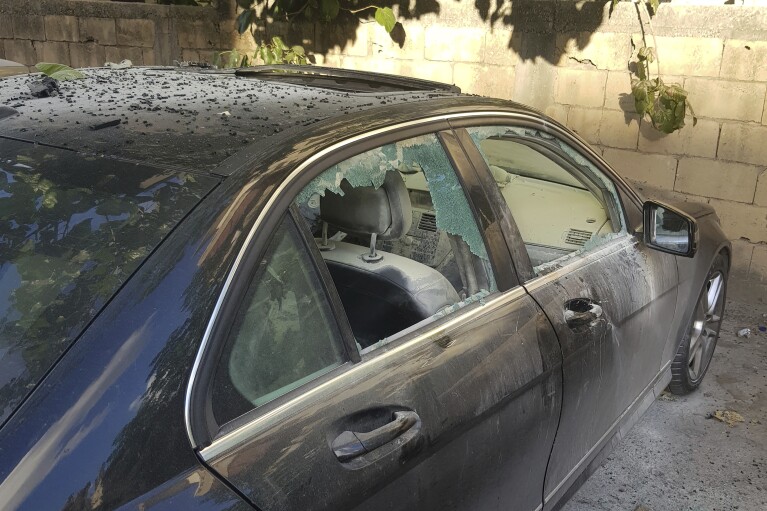 A partly damaged car after what is believed to be the result of a walkie-talkie exploding inside it, in the southern port city of Sidon, Lebanon, Wednesday, Sept. 18, 2024. (AP Photo/Mohammed Zaatari)