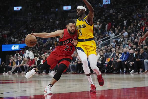 Toronto Raptors guard Fred VanVleet (23) drives as Indiana Pacers forward Justin Holiday (8) defends during the first half of an NBA basketball game, Wednesday, Oct. 27, 2021 in Toronto. (Nathan Denette/The Canadian Press via AP)
