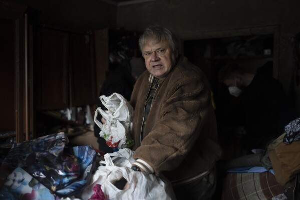 Serhii Slobodiannyk, 63, stands inside of his apartment that was damaged as a result of Russia's attack on Jan. 2 in Kyiv, Ukraine, Wednesday, Jan. 3, 2024. "Everything I worked for over 30 years was destroyed in less than a second," he says. (AP Photo/Hanna Arhirova)