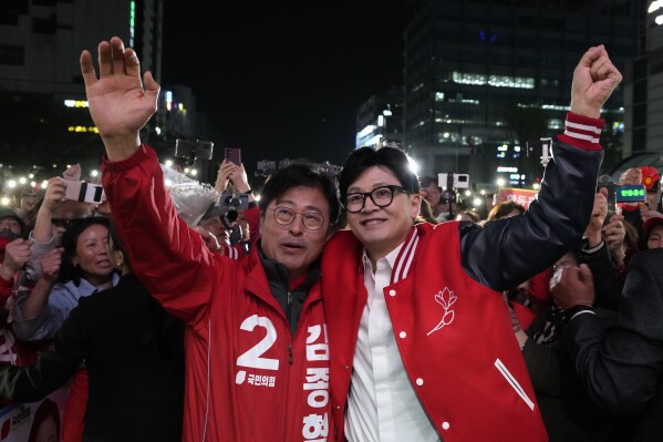 The ruling People Power Party's leader Han Dong-hoon, right, reacts with his party's candidate Kim Jong-hyeok during a campaign rally for the upcoming parliamentary election in Goyang, South Korea, Monday, April 8, 2024. As South Koreans head to the polls to elect a new 300-member parliament on this week, many are choosing their livelihoods and other domestic concerns as the most important election issues. It's in a stark contrast from past elections that were overshadowed by security and foreign policy issues like North Korean nuclear threats and U.S. security commitment for South Korea. (AP Photo/Ahn Young-joon)