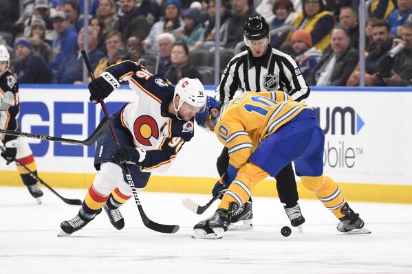 Colorado Avalanches' Mikko Rantanen takes the face-off against St. Louis Blues center Brayden Schenn during the first period of an NHL hockey game, Sunday, Dec. 11, 2022, in St. Louis. (AP Photo/Jeff Le)