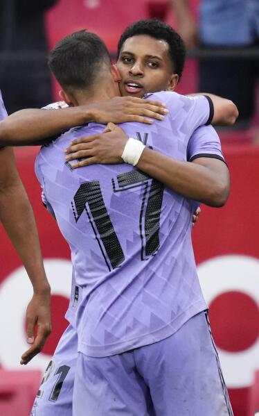 Real Madrid's Rodrygo, top, celebrates with David Alaba after scoring his  side's first goal during a Spanish La Liga soccer match between Sevilla and Real  Madrid at the Ramon Sanchez Pizjuan stadium