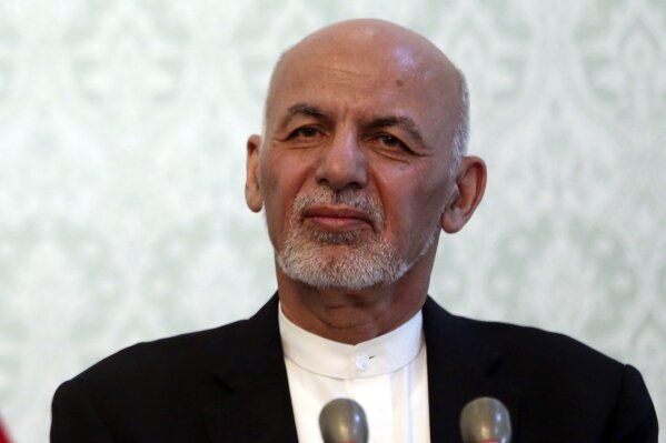 FILE - In this Nov. 6, 2018 file photo, Afghan President Ashraf Ghani, listens during a news conference with NATO Secretary General Jens Stoltenberg, at the presidential palace, in Kabul, Afghanistan. While there will be 18 names on the presidential ballot when Afghans go to the polls on Sept. 28 only five, including Ghani, have been campaigning after several suspended their campaigns believing a peace deal with the Taliban was imminent. (AP Photo/Massoud Hossaini)