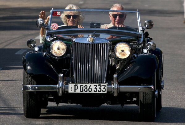 FILE - In this March 26, 2019 file photo, Prince Charles drives a vintage car with his wife Camilla, Duchess of Cornwall, during a cultural event in Havana, Cuba. Britain’s Prince Charles has chose...