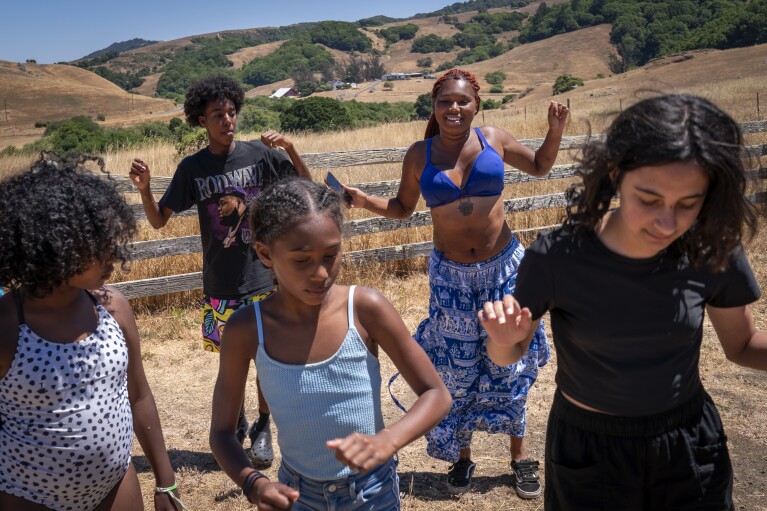 Satya Sheftel-Gomes, 22, of San Francisco, back right, leads campers including Abelli Daija James, 15, of San Diego, back left, through choreography for a friendly dance competition during Camp Be’chol Lashon, a sleepaway camp for Jewish children of color, Saturday, July 29, 2023, in Petaluma, Calif., at Walker Creek Ranch. “Early on when I had less connections it really felt like I was one in a million,” says Sheftel-Gomes, “and camp has always been such a special place where there’s such an intersection of identities.” (AP Photo/Jacquelyn Martin)