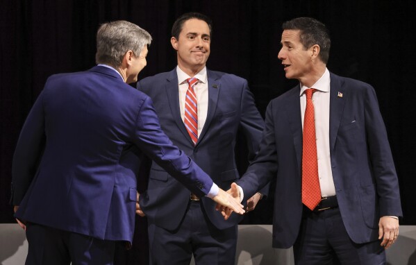 Ohio Republican Senate candidates from left Rep. Matt Dolan, Ohio Secretary of State Frank Larose, and Bernie Moreno greet each other before a forum, Monday, Feb. 19, 2024, in the TLB Auditorium at the University of Findlay in Findlay, Ohio. (Jeremy Wadsworth/The Blade via AP)