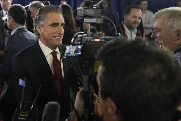 North Dakota Gov. Doug Burgum speaks to reporters in the spin room after a Republican presidential primary debate hosted by FOX News Channel Wednesday, Aug. 23, 2023, in Milwaukee. (AP Photo/Morry Gash)