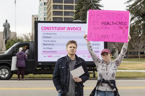 FILE - Blake Coker and Autumn Myers protest Senate Bill 1309, the Fetal Heartbeat Protection Act, during a rally at the Idaho Capitol on Saturday, March, 19, 2022 in Boise, Idaho. Idaho on Wednesday, March 23, 2022, became the first state to enact a law modeled after a Texas statute banning abortions after about six weeks of pregnancy and allowing it to be enforced through civil lawsuits to avoid constitutional court challenges. (Sarah A. Miller/Idaho Statesman via AP, File)