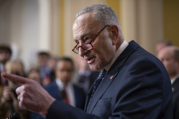 Senate Majority Leader Chuck Schumer, D-N.Y., answers questions on the border security talks as he meets reporters following a Democratic caucus meeting, at the Capitol in Washington, Wednesday, Jan. 31, 2024. (APPhoto/J. Scott Applewhite)