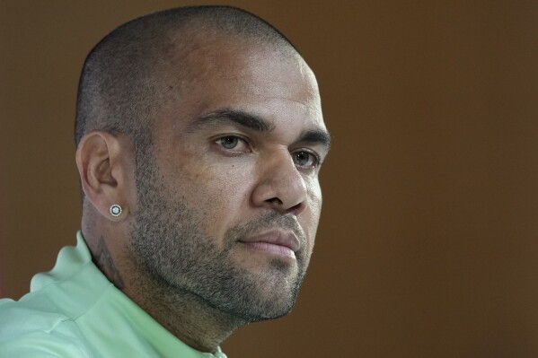 FILE - Brazil's Dani Alves listens to a question during a press conference on the eve of the group G of World Cup soccer match between Brazil and Cameroon in Doha, Qatar, on Dec. 1, 2022. A Barcelona-based court says that Brazilian soccer star Dani Alves’ sexual assault trial will start on Feb. 5. Alves is accused of allegedly sexually assaulting a young woman in a Barcelona night club last in December 2022. (AP Photo/Andre Penner, File)