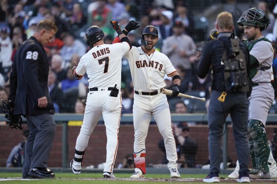 San Francisco Giants' J.D. Davis (7) celebrates with Michael Conforto after hitting a two-run home run against the Oakland Athletics during the first inning of a baseball game Wednesday, July 26, 2023, in San Francisco. (AP Photo/Godofredo A. Vásquez)