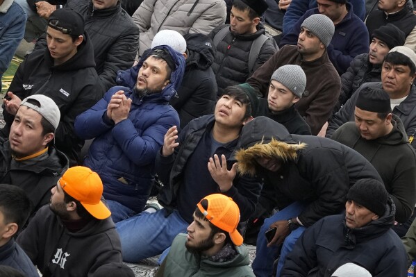 Muslims pray outside a mosque as they celebrate Eid al-Fitr, marking the end of the Muslims' holy fasting month of Ramadan, in St. Petersburg, Russia, Wednesday, April 10, 2024. (AP Photo/Dmitri Lovetsky)