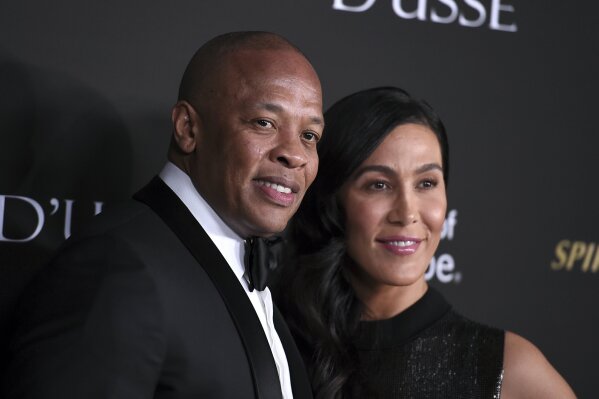 FILE - In a Thursday, Oct. 11, 2018 file photo, Dr. Dre, left, and Nicole Young arrive at the City of Hope Gala, at the Barker Hangar in Santa Monica, Calif. Dr. Dre’s wife of 24 years Nicole Young...